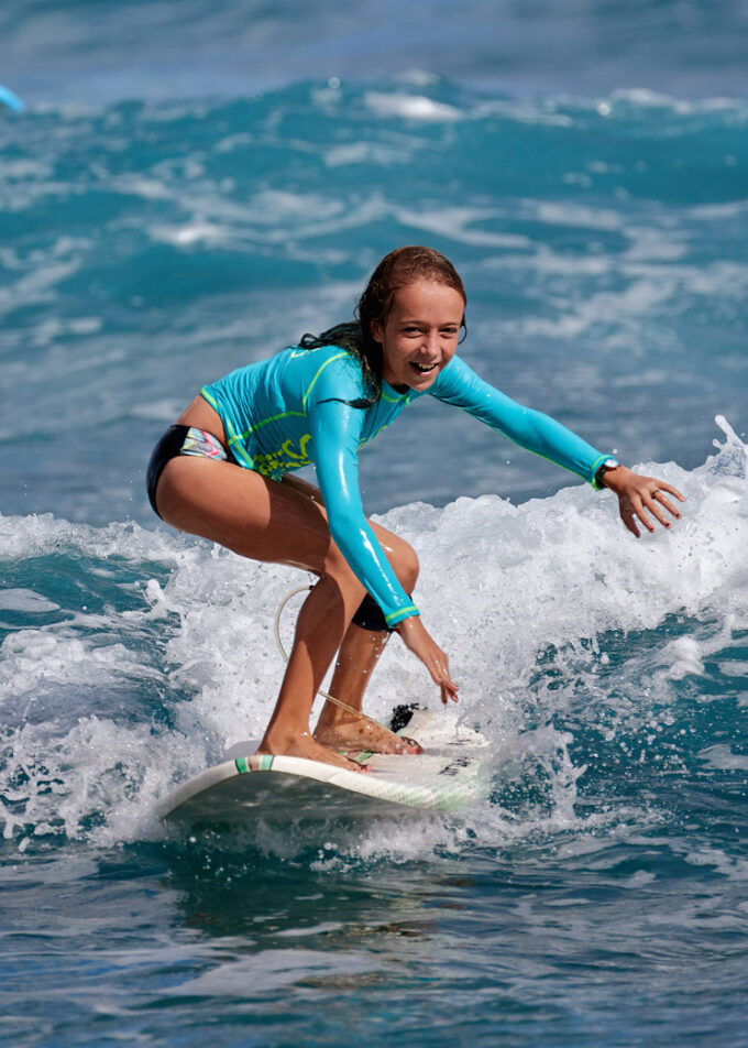 Surfer school. Beautiful young woman in swimsuit. Surfer on the wave. beautiful ocean wave. Water sport activity. Atlantic Ocean, Dominican Republic. 29.12.2016.